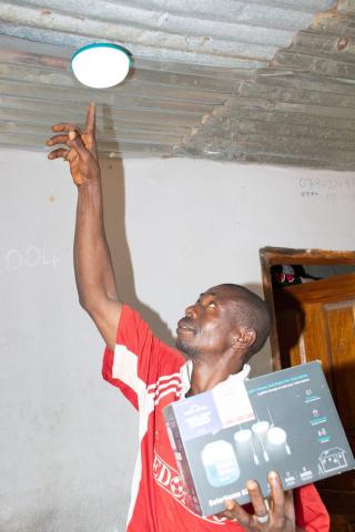 A resident electrifying his home in Mamakuma village