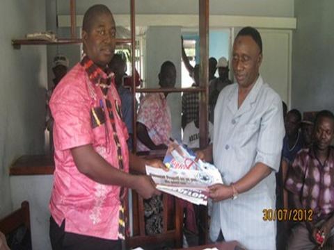 ACC Manager North, Patrick Sandi handing over IEC materials to SALWACO Regional Boss, Alimamy Kargbo