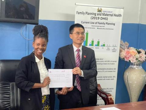 Ambassador Wang presenting the 20,000 dollars to the Deputy Minister of Health II