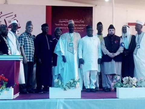 Amir of Ahmadiyya and President Bio flanked by members of teh faith