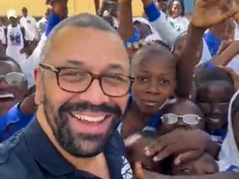 James Cleverly with children at a school in Bo