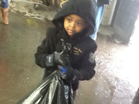 Ibrahim collecting cans in cold weather