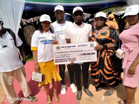 Trust Microfinance display Munafa Fund Cheque
