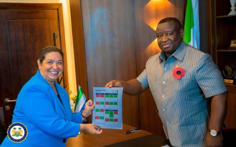 US Ambassador Brewer presenting MCC Scorecard to President Bio
